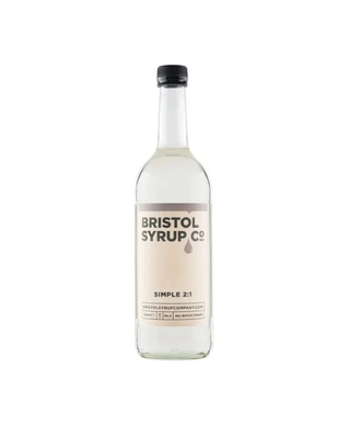 A clear glass bottle of Bristol Syrup Co. Simple 2:1 syrup with a beige label and black cap, centered on a plain white background.