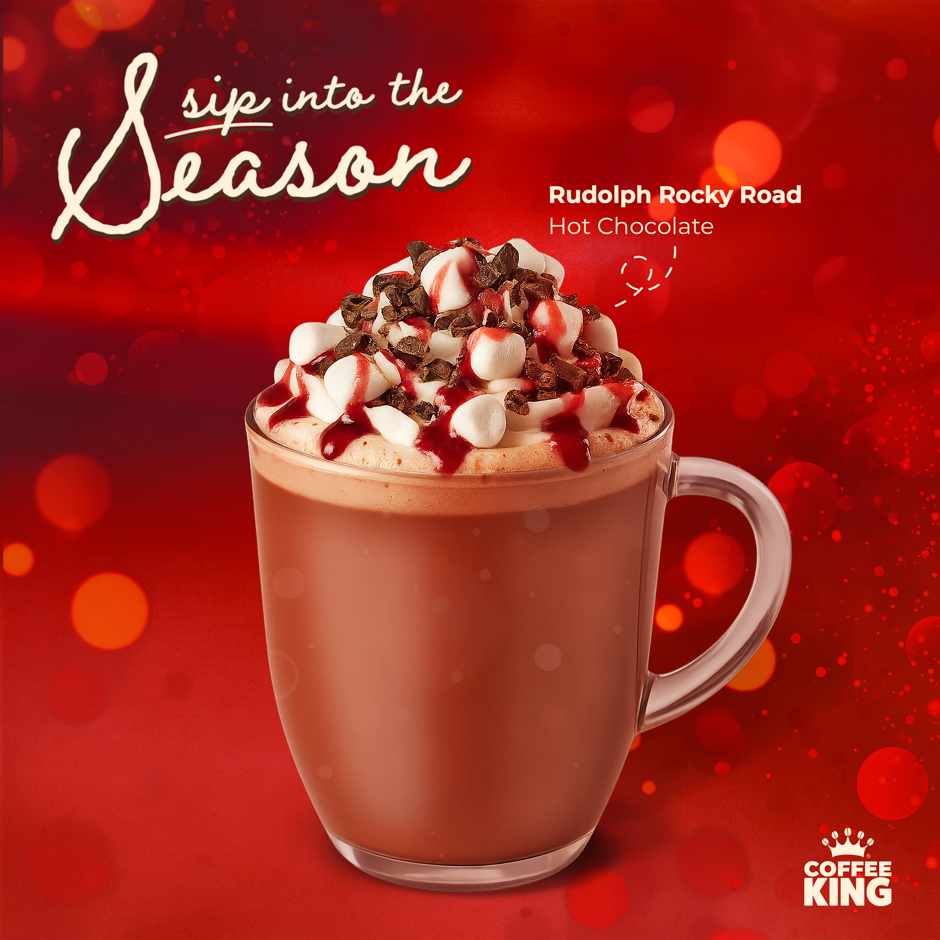 Hot chocolate with whipped cream and chocolate shavings on a red background with 'Coffee King' branding.