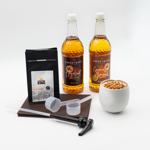 Beverage and coffee products including bottles, a coffee bag, and a measuring tool on a white background.