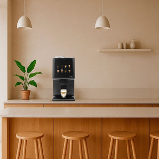 Compact Azkoyen Vitro S1 Espresso on a breakfast bar counter with stools