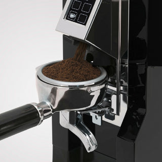 Eureka Mignon Specialita grinding coffee directly into a portafilter, black finish with touch display