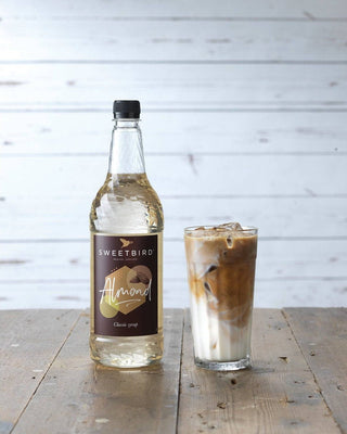 Bottle of Sweetbird Almond Syrup, 1 litre bottle, nut-free Bakewell tart flavour for lattes and hot chocolate and Almond iced latte 